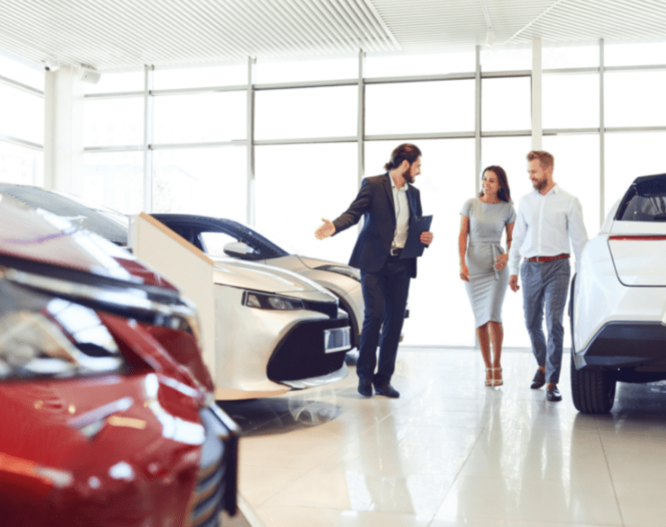 Dealership cleaning specialists removing dust from vehicle displays
