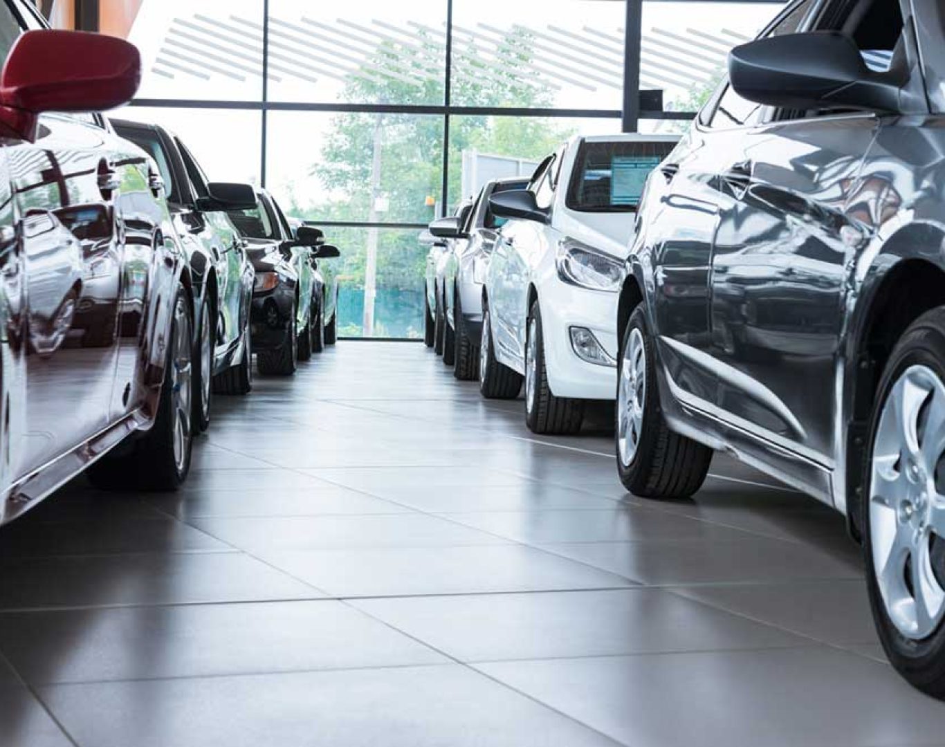 Dealership cleaning crew vacuuming carpets in sales offices