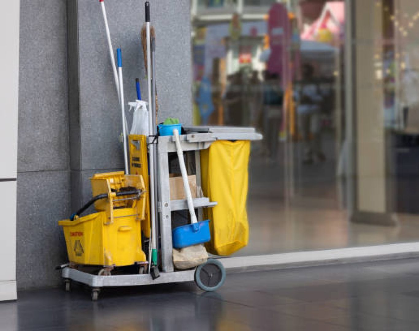 Janitorial team cleaning office floors with professional equipment