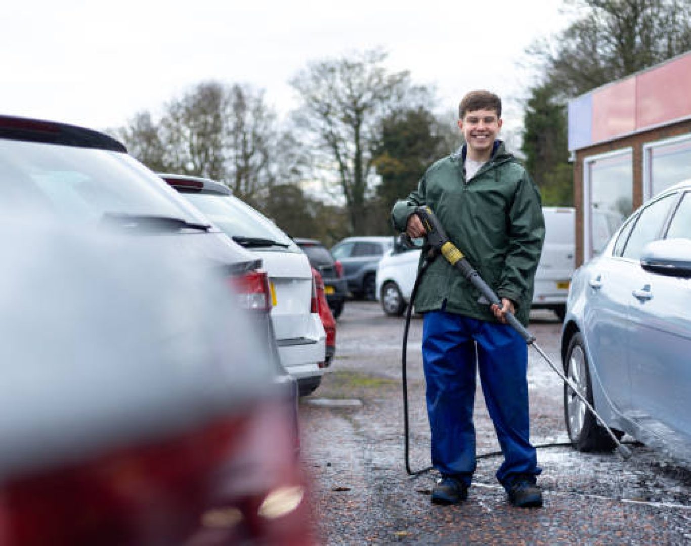 Dealership cleaning staff maintaining showroom floors at automotive dealership