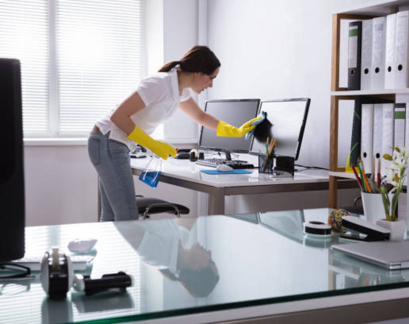Office cleaner maintaining professional workspace in Boca Raton, FL building